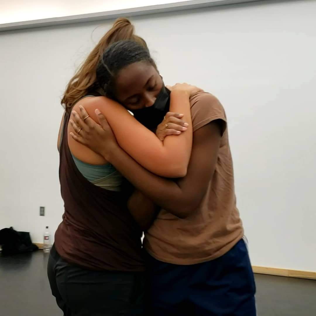 Nikki d’Arnault and Faith Mondesire hug each other tightly.